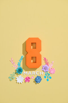 International Women's Day Celebration with Flowers and March 8 Sign