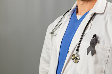 Healthcare worker with stethoscope and awareness ribbon