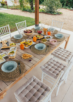 Outdoor dining setup with delicious snacks on rustic table