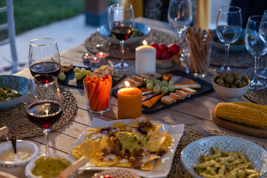 Cozy evening dinner with wine, candles, and appetizers