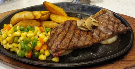 Grilled Steak Dinner with Potato Wedges and Veggies