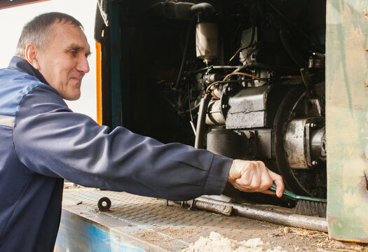 A worker is cleaning the engine.