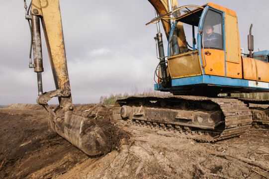The excavator is leveling the ground.