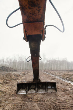 The bucket drips earth.