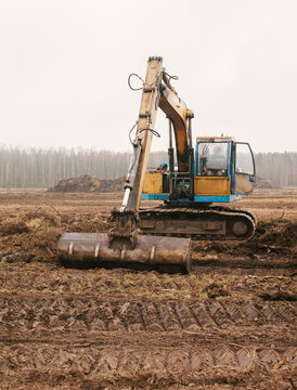 The excavator is leveling the ground.