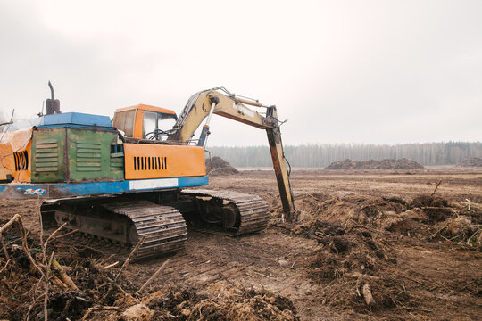 The excavator is leveling the ground.