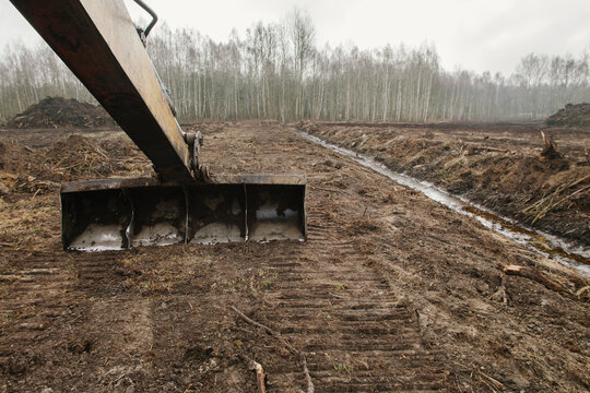 The bucket drips earth.