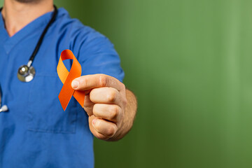 Healthcare worker promotes awareness with orange ribbon during campaign