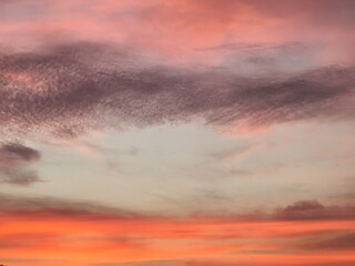 The evening sky is blue with multi-colored clouds, white, grey, pink, purple, golden yellow, orange, and vanilla.