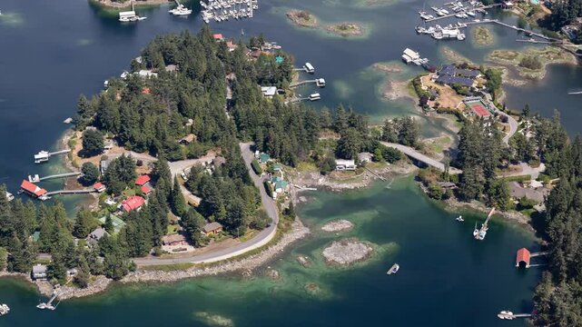 Aerial view of Sechelt, British Columbia, Canada. Coastal community, houses, boats, and lush trees.