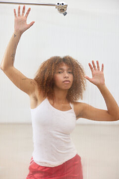 Black woman behind plexiglass in studio