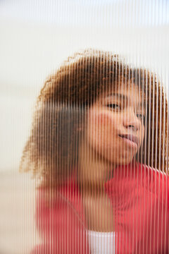 Black woman pressing face against glass