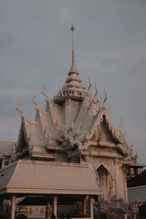 The Intricate Temple Architecture Beautifully Stands Out Under Cloudy Skies at Dusk