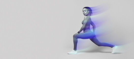 Sporty African American woman lunging forward exercising during workout over pink studio background, looking at camera with confidence. Gym training for muscles flexibility. Side view shot