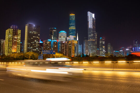 Cars drive quickly through the city