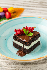 Chocolate mint brownie with cream filling, chocolate sauce, and berries