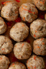 Homemade meatballs close-up cooked in a frying pan, top view
