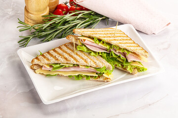Homemade club sandwich with ham and cheese
