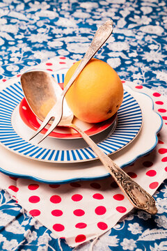 Colorful dishes arranged with a lemon on a decorative tablecloth