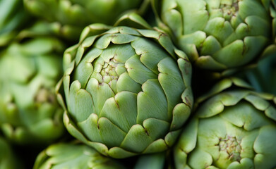 Obraz premium Close-up of fresh, green artichokes stacked together.