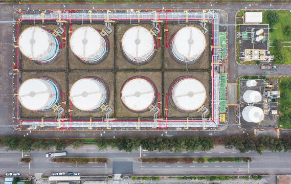 Industrial Storage Tanks Aerial View with Pipelines and Roadside