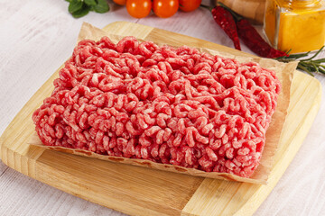Raw minced beef meat over board