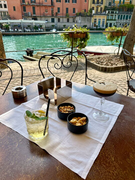 Aperitivo at a sidewalk cafe in Peschiera Del Garda, Italy