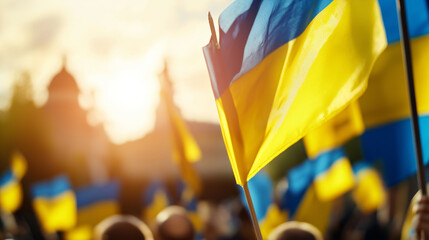 Ukrainian flags waving in the sunlight during a protest or celebration, symbolizing national pride.