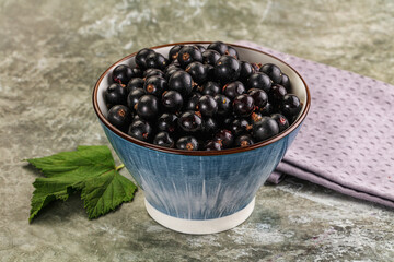 Ripe black currant in the bowl