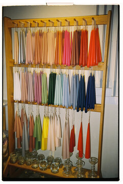 Display of colorful taper candles in a workshop setting