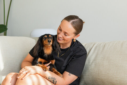 Happy woman enjoying time with her pet dog
