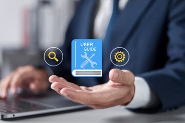 User manual guide concept, Online instruction manual and strategy advice. Businessman using laptop...