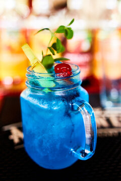 Blue drink in mason jar with garnish