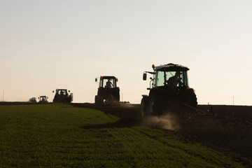 Fototapeta premium Convoy of Tractors on country road.