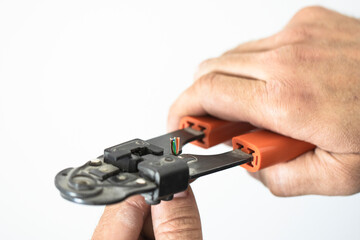 Fototapeta premium Mechanic strips and connects wires to the network, close-up of tools.