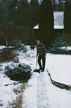 A man is shoveling snow.