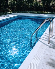 Serene Pool with Shimmering Water and Stainless Steel Ladder Reflecting Sunlight