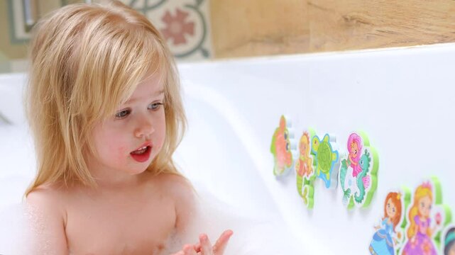 Little child girl caucasian bathing in a bubble bath