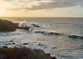 Waves crashing on volcanic shore