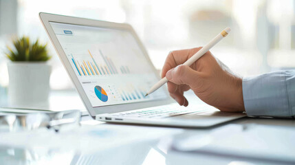 Business professional analyzing data with laptop and digital charts
