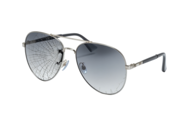 Cracked aviator sunglasses, symbolizing vulnerability and unexpected accidents