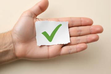 A hand holding a torn piece of paper with a green check mark on a neutral background. Concept of approval, success, or verification. Ai generative