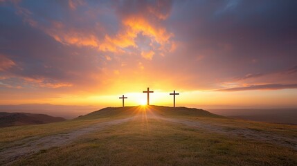 Obraz premium Three crosses silhouetted against a stunning colorful sunset sky with dramatic clouds and a peaceful serene landscape in the foreground