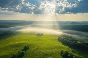 Aerial View of Sun Rays Breaking Through Clouds Over Lush Green Valley
