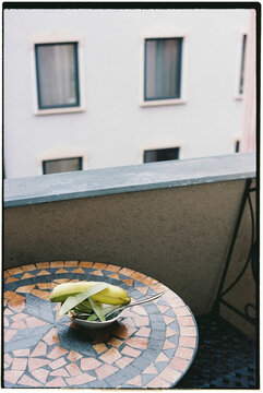 peels of different fruits on an outdoor table, 35mm