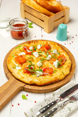 Italian pizza with salmon and cheese on a wooden board.