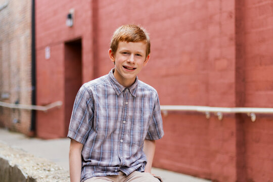 Portrait of teenage boy in alleyway, looking at camera