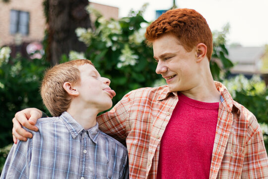 Younger Brother Sticking out his Tongue at his Older Brother