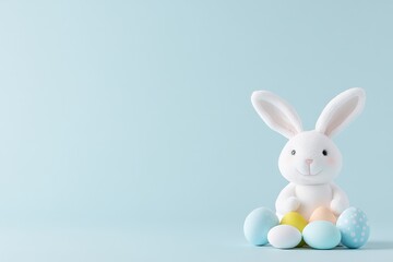 Obraz premium Minimalistic pastel blue background with two white Easter bunny figurines and colorful eggs symbolizing festive celebration simplicity and holiday charm