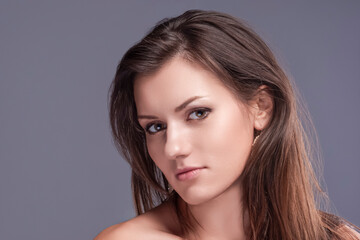 Fototapeta premium Beauty Concepts. Cute Portrait of Long hear Healthy Woman With Healthy Beauty Silk Skin as Face Closeup Portrait For Cosmetics and Cosmetology Ideas.